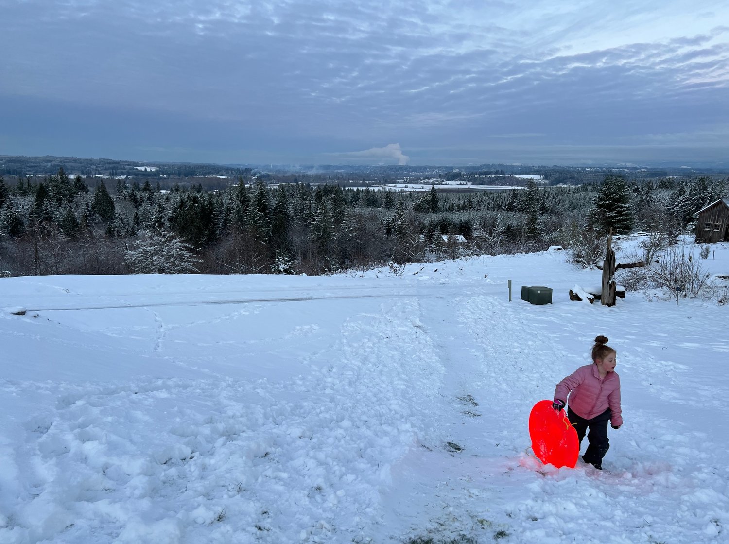"Sledding in Adna! Charlotte has had a lot of fun playing and building a little snowman, and sledding with her parents." — submitted by Jessie Garman